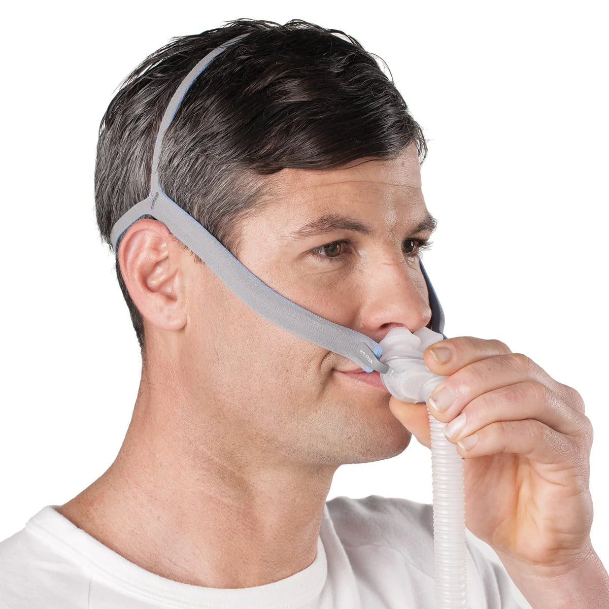Man using a CPAP mask on a white background